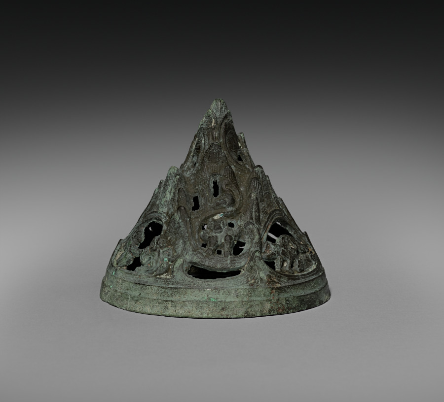 The pierced mountain-shaped bronze cover of a Western Han boshanlu, shown separately from its lower cup